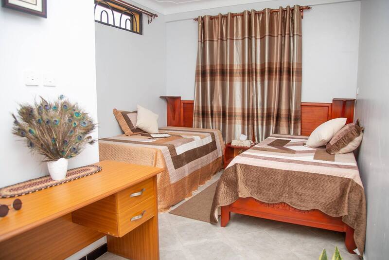 Twin bedroom with desk and workspace