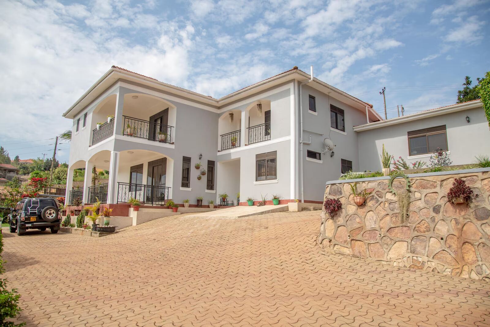Crystal HomeStay exterior with balconies and parking for multiple vehicles